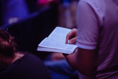 selective focus photo of person holding book