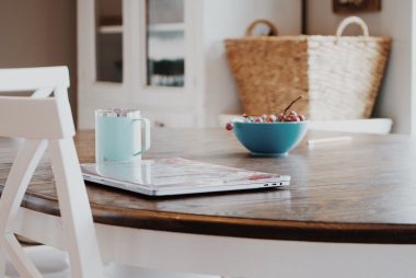 laptop placed on round table in light living room