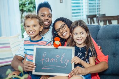 a happy family sitting on the sofa