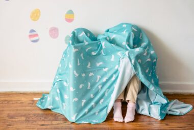 kids hiding under easter blanket